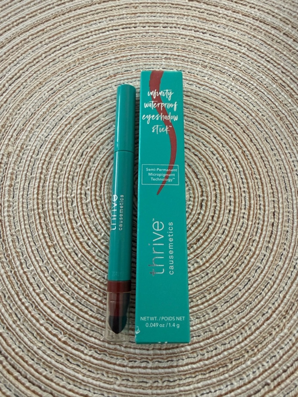 Thrive Causemetics Teal Packaging with Burgundy Cream Eyeshadow Stick